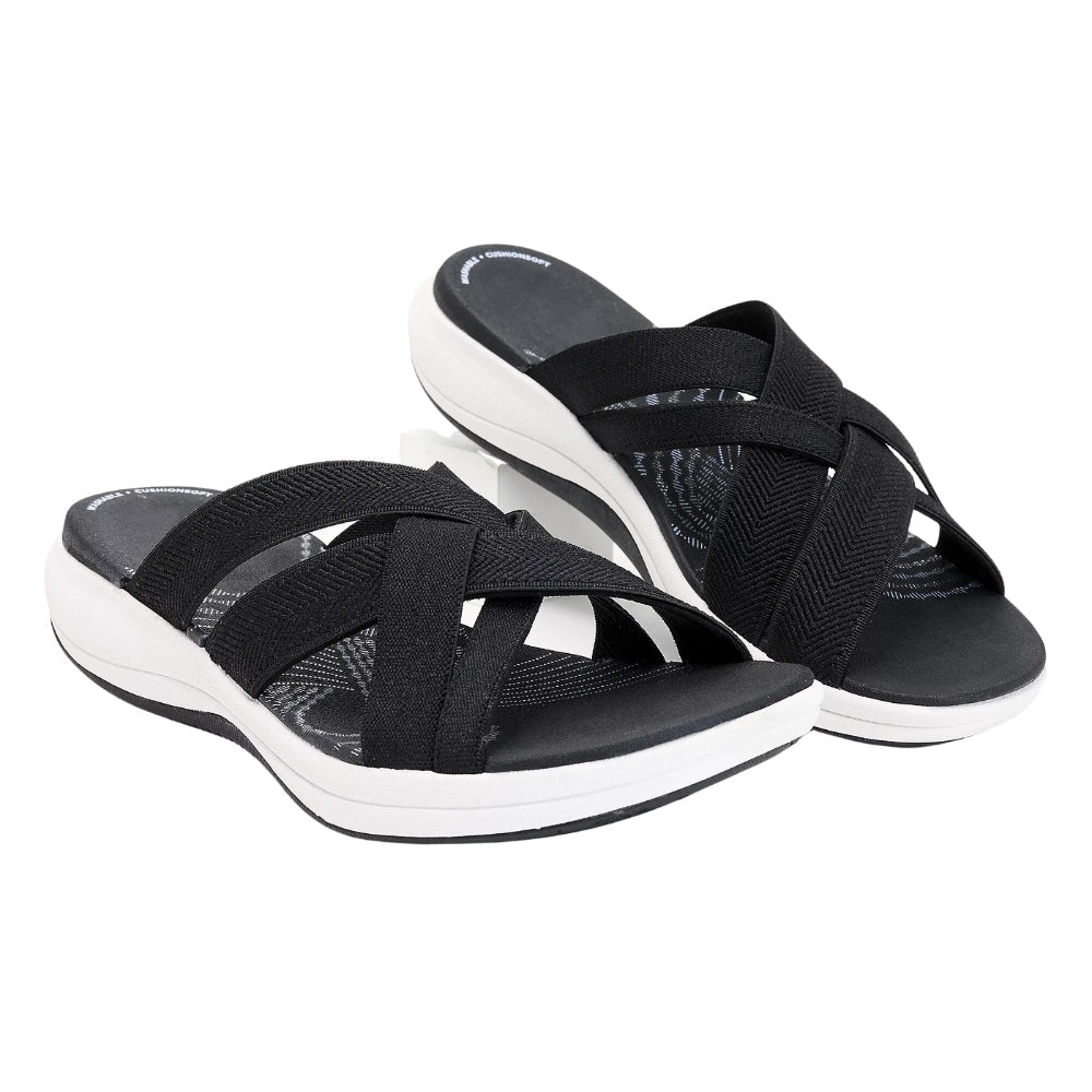 Schwarze Damen-Sandalen mit überkreuzten Riemen und weißer Sohle, bequemes Design, ideal für Sommermode und Freizeitkleidung.