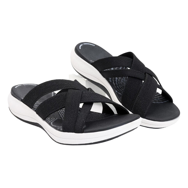 Schwarze Damen-Sandalen mit überkreuzten Riemen und weißer Sohle, bequemes Design, ideal für Sommermode und Freizeitkleidung.
