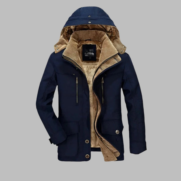 Dunkelblaue Herrenjacke mit Kapuze, Reißverschlüssen und beigem Futter. Stilvolle Winterjacke, warm und modisch, ideal für kalte Tage.