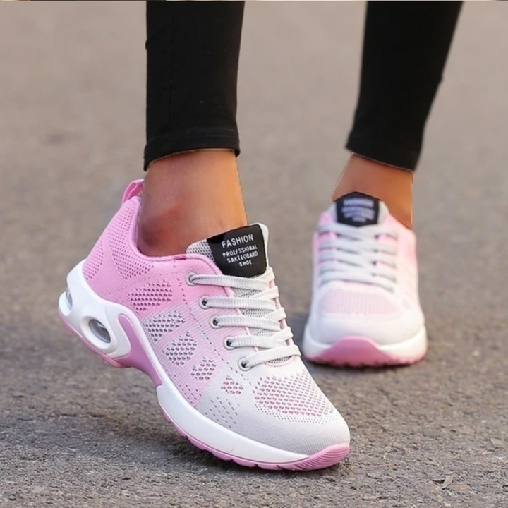Damen Sneaker in Rosa und Weiß, atmungsaktiv, mit Schnürsenkeln und gepolsterter Sohle, ideal für Laufen und Freizeitmode.