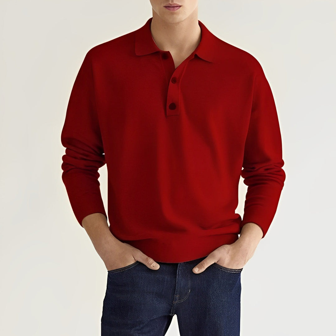 Roter Pullover Herrenmode, langärmlig, mit Kragen und Knopfleiste, kombiniert mit dunkelblauer Jeans. Eleganter Freizeitlook für Männer.
