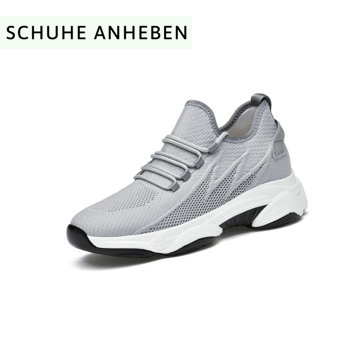 Grauer Sneaker mit dicker, weißer Sohle und schwarzem Akzent, atmungsaktives Mesh-Obermaterial, ideal für Sport und Freizeit.