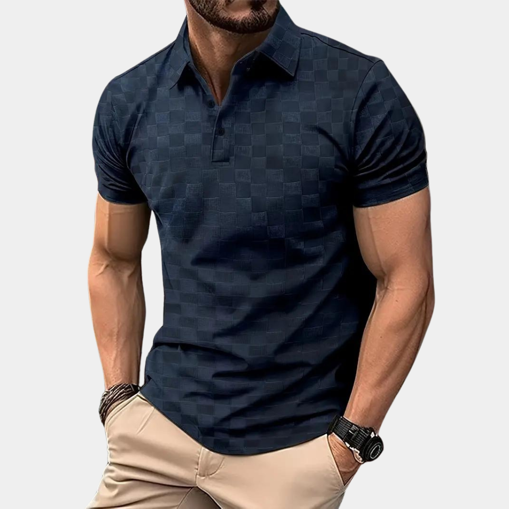 Mann in dunkelblauem kariertem Poloshirt, muskulös, trägt beige Hose, Armbanduhr und Armband. Elegante Herrenmode, Freizeitlook.