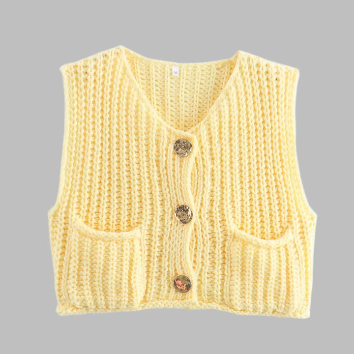 Gelbe Strickweste mit V-Ausschnitt, drei dekorativen Knöpfen und zwei Taschen, isoliert auf grauem Hintergrund. Modetrend, Damenbekleidung, Strickmode.