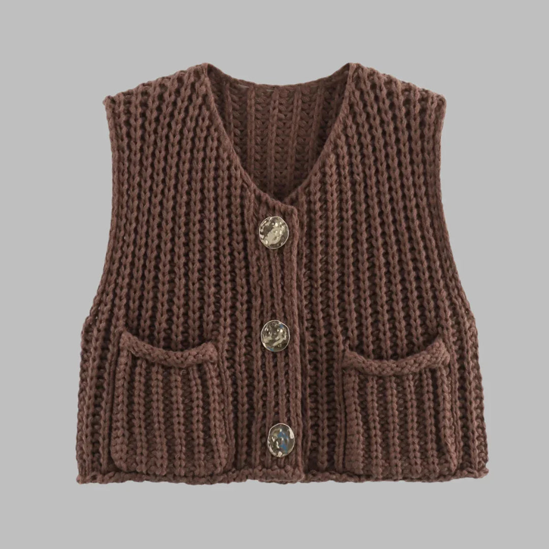 Braune, handgestrickte Weste mit V-Ausschnitt, drei Knöpfen und zwei Taschen, ideal für Herbstmode. Perfekt für stilvolle, warme Outfits.