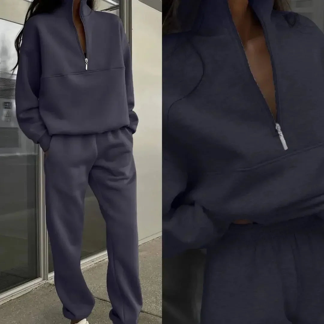 Dunkelgrauer Jogginganzug mit Reißverschluss, lässig und modern, ideal für Freizeit und Sport. Bequeme Passform, trendige Streetwear-Mode.