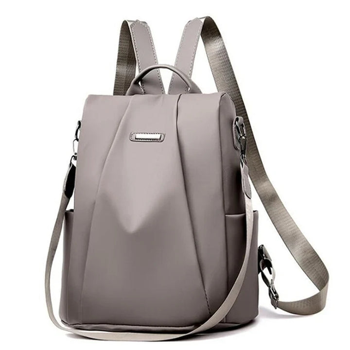 Grauer, wasserdichter Damen-Rucksack mit verstellbaren Trägern und mehreren Fächern. Stilvoller, moderner Tagesrucksack für Schule oder Reisen.
