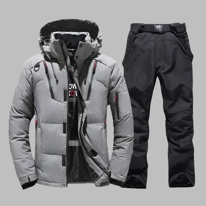 Graue Winterjacke und schwarze Skihose für Herren, wasserdicht und winddicht, ideal für Outdoor-Aktivitäten und Wintersport.