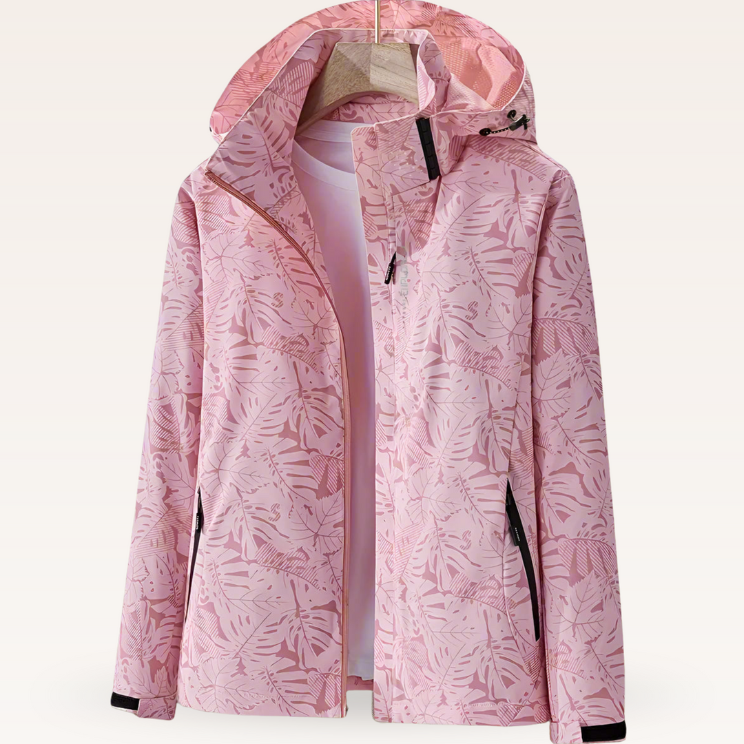 Rosa Damenjacke mit tropischem Blattmuster, Kapuze und Reißverschlusstaschen. Modische Outdoor-Bekleidung, ideal für Frühling und Herbst.