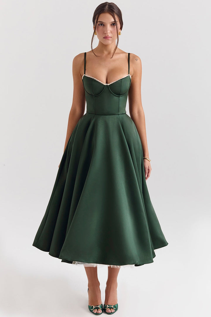Frau in elegantem, grünem Abendkleid mit Spaghettiträgern und ausgestelltem Rock, ideal für formelle Anlässe. Elegante Mode, Abendgarderobe.