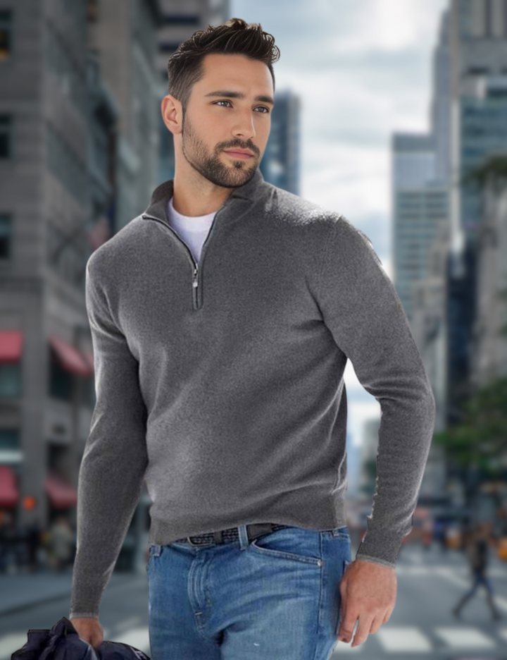 Mann in grauem Pullover und blauer Jeans in urbaner Umgebung. Mode, Herrenbekleidung, Stadt, Freizeitlook, stilvoller Mann.