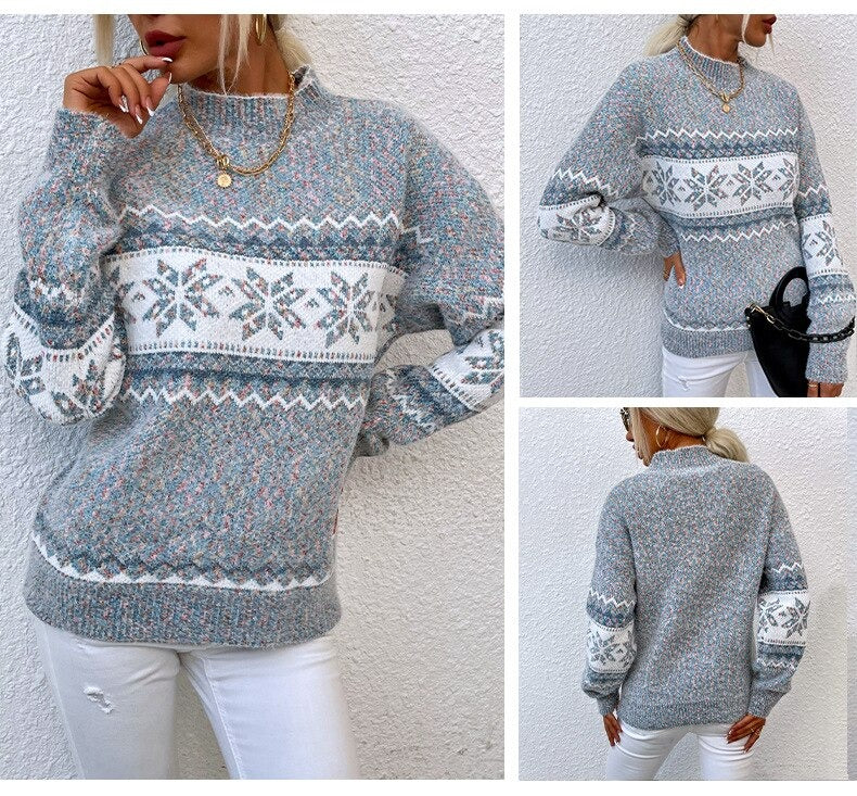 Frau trägt grauen Strickpullover mit Schneeflockenmuster, kombiniert mit weißen Jeans. Modischer Winterlook, ideal für kalte Tage.