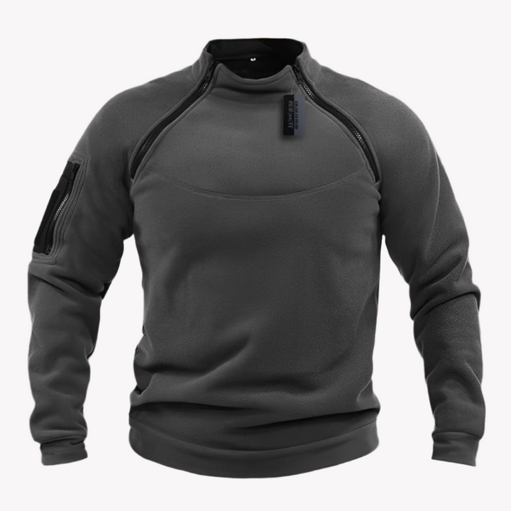 Grauer taktischer Pullover mit Reißverschlüssen und Armtasche, ideal für Outdoor-Aktivitäten. Hochwertiges Material, perfekt für Herbstwetter.